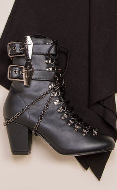 The Vivika 128 is a Victorian industrial gothic-inspired ankle length lace-up boot. Perfect with anything from ballgowns to skinny jeans. Check out the Coffin buckle detail! Vegan Black PU leather 3-inch block heel Coffin Buckles Removable Chains Lace-up front and with side Zip U.S women's sizing - refer to size chart for more info Victorian Industrial, Edgy Heels, Black Lace Boots, Demonia Boots, Victorian Shoes, Victorian Boots, Goth Boots, Demonia Shoes, Gothic Shoes