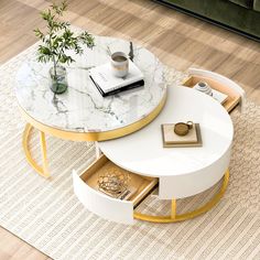 a white and gold coffee table with two drawers underneath it on a rug in front of a couch