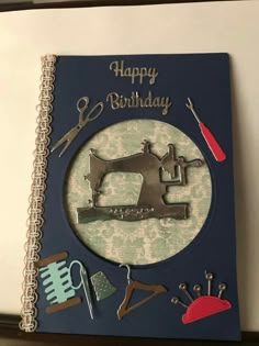 a happy birthday card with a sewing machine and tools on the front, surrounded by other crafting items