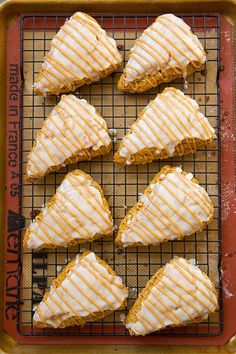 there are six glazed pastries on the baking rack, ready to be baked in the oven