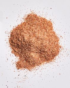 a pile of ground spices sitting on top of a white table