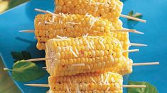 corn on the cob with toothpicks and parmesan cheese