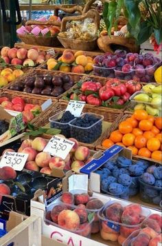 an assortment of fruits and vegetables on display at a market