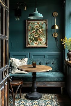 a room with green walls and a table in the corner, next to a blue couch