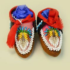 a pair of shoes with beaded decorations on them