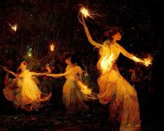 three women in yellow dresses are holding sparklers and firecrackers as they walk through the night