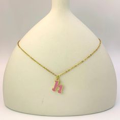 Add a touch of personality and whimsy to your look with our Personalized Pink Initial Necklace. This charming necklace features a custom letter of your choice, crafted with a gold-plated finish and filled with vibrant pink enamel. The delicate chain complements the playful letter, creating a cheerful and eye-catching piece. Perfect for everyday wear or as a gift, this necklace is a delightful way to express your unique style. Pink Initial Pendant Jewelry For Mother's Day, Pink Pendant Charm Necklace With Delicate Chain, Trendy Gold Charm Necklaces For Personalized Gift, Pink Enamel Jewelry For Birthday, Pink Pendant Charm Necklace, Pink Jewelry With Charms For Personalized Gift, Pink Gold Necklace With Charms For Gift, Pink Necklace With Adjustable Chain For Her, Trendy Pink Gold Plated Jewelry