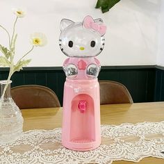 a hello kitty water dispenser sitting on top of a table