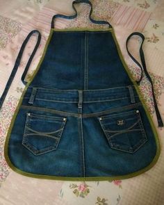 an apron made out of jeans is laying on the bed