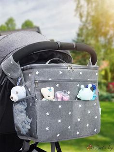 the baby stroller is packed with various items in its pocket and attached to it's side