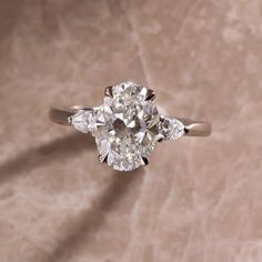 an oval diamond ring with three pear shaped diamonds