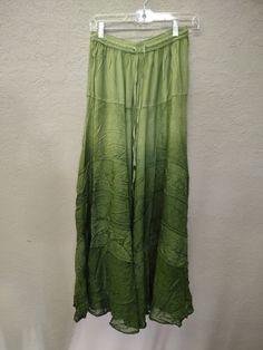 a green skirt hanging up against a wall