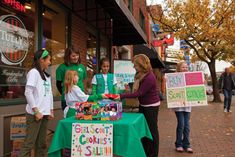 a group of people standing around a table with signs