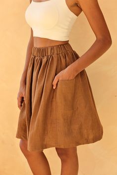 The gathered linen skirt provides a comfortable fit with a stylish, flared silhouette. Handcrafted in our studio to your measurements and preferences, available in over 60 colors. STYLE DETAILS - 100 % linen, medium weight (200gsm), free-shrinkage, amazingly soft feel - High waisted - Elastic waistband - Gathered skirt - Seam pockets - Above-the-knee length 20''/50cm/size S for our lovely model 5ft5/169cm tall. - Custom made skirt, FREE customizations; simply let us know your needs - Handcrafted Relaxed Tiered Skirt With Gathered Waist, Linen Flared Gathered Skirt, Relaxed Linen Skirt With Elastic Waistband, Linen Skirt With Side Pockets And Relaxed Fit, Linen Tiered Maxi Skirt With Elastic Waistband, Knee-length Skirt With Gathered Waist, Linen Skirted Bottoms With Pockets, Skirted Linen Bottoms With Pockets, Linen Midi Maxi Skirt With Gathered Details