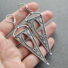 Boho Triangle Earrings: Beautiful, bold, and totally versatile, these silver dangle earrings are equally suited to a music festival or a downtown cafe. They'll make you feel like the goddess you are! ✧ 3.25 inches long ✧ Comfortably lightweight at 5 grams each (same as a US nickel) ✧ Leverback hooks in your choice of silver-plated, stainless steel, or sterling silver ✧ Gift-ready in attractive, earth friendly box ✧ Handmade just for you, ready to ship in 3-6 business days SHOP EARRINGS: https:// Bohemian Adjustable Triangle Earrings, Bohemian Triangle Adjustable Earrings, Adjustable Bohemian Triangle Earrings, Triangle Metal Earrings For Gift, Vintage Festival Earrings With Ear Wire, Triangle Earrings As Gift, Triangle Pierced Earrings As Gift, Triangle Pierced Earrings Gift, Artistic Metal Dangle Earrings