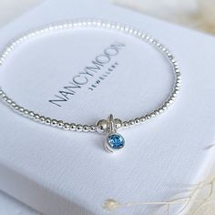 The birthstone for March is aquamarine which signifies happiness and hope. This dainty bracelet is the perfect accessory to someone special with a March birthday. Lovingly handcrafted onto strong stretch elastic using the highest quality sterling silver round beads, this delicate charm bracelet is both elegant and hypoallergenic. Designed to suit all skin tones, it will add a meaningful yet luxurious touch to your everyday look which you can stack with any other pieces from the Nancy Moon collec Beaded Boho Jewelry, Bracelets With Meaning, March Birthday, Aquamarine Bracelet, Dainty Bracelet, March Birthstone, Moon Jewelry, Dainty Bracelets, Birthstone Charms