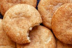 a pile of cinnamon sugar cookies with one bite taken out