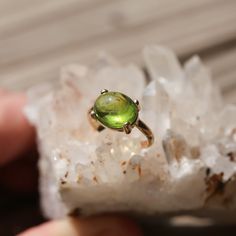 This gorgeous solid gold and Peridot ring has everything you want in a 14 KT Gold Peridot Statement Ring. Gorgeous, smooth Green Peridot cabochon - 8 CT - highlighted and set in 14KT GOLD setting - made to order. Choose your size in the listing. We wanted to show off this gorgeous Peridot Stone in a strong, solid gold prong setting with half-round prongs mimicking the soft cut of this gorgeous, natural Peridot stone. You will love the classic, translucent grass-green peridot in gold. This lovely Yellow Gold Polished Peridot Jewelry, Yellow Gold Peridot Jewelry With Polished Finish, Yellow Gold Tourmaline Solitaire Jewelry, Oval Peridot Solitaire Jewelry, Polished Peridot Jewelry, Oval Solitaire Tourmaline Jewelry, Oval Tourmaline Solitaire Jewelry, Round Peridot Jewelry With Polished Finish, Polished Peridot Jewelry For May Birthstone