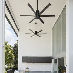 a ceiling fan mounted to the side of a white wall