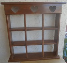 a wooden shelf with hearts on it