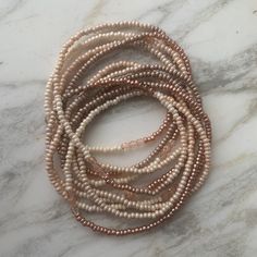 Soft, soothing tones -- eggshell to french vanilla to pale taupe to mocha -- blend into a nearly seamless ombre, sparked with stretches of metallic pearl blush seed beads and trios of pale-blush faceted fire-polished Czech glass beads. Wear as a wrap bracelet of many different ways as a necklace. --- LENGTH: Approximately 78 inches, to wrap around the wrist 11 or 12 times. Can be wrapped around the neck 5 times to make a short choker, or worn in long loops, knotted, layered. See photos for ideas Adjustable Multi-strand Beige Necklaces, Adjustable Multi-strand Beige Necklace, Adjustable Pearl Bracelets, Adjustable Cream Pearl Bracelets, Elegant Adjustable Beige Beaded Necklace, Elegant Beige Adjustable Beaded Necklace, Handmade Cream Pearl Beaded Bracelets, Adjustable Cream Pearl Beaded Bracelets, Adjustable Cream Pearl Beaded Bracelet