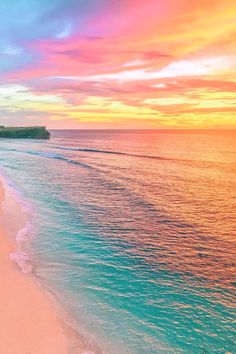 the beach is lined with white sand and blue water as the sun sets over the ocean