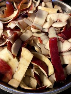 sliced apples are in a metal bowl on the stove top, ready to be cooked