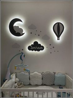 a baby's nursery room decorated in white and black with hot air balloons above the crib