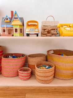 baskets and toys are lined up on a shelf