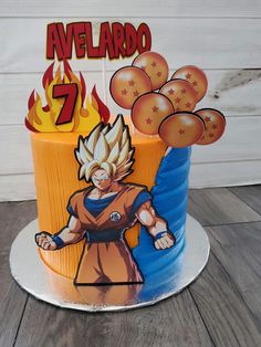 a birthday cake with the image of gohan on it and balloons in the air