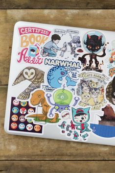 a laptop with many stickers on it