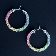 A beautiful mini rainbow for your ears! Blue, green, yellow, orange, fuchsia and silver glass beads on sterling silver earring wire with sterling silver accent beads.  Sterling Silver (100% Post Consumer Recycled ear wire)  Glass Beads UV (Black light) reactive Length about 1.2 inches Made in Tucson, AZ Silver Small Hoop Beaded Earrings With Ear Wire, Silver Hoop Earrings With Colorful Beads As Gift, Multicolor Hoop Earrings With Ear Wire, Rainbow Round Beads Jewelry With Ear Wire, Rainbow Nickel-free Dangle Hoop Earrings, Nickel Free Silver Small Hoop Beaded Earrings, Nickel-free Silver Small Hoop Beaded Earrings, Nickel-free Rainbow Round Beaded Earrings, Nickel-free Rainbow Dangle Hoop Earrings