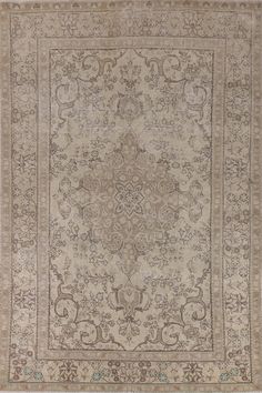 an antique rug with many different designs and colors on the carpet is shown in grey, beige