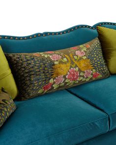 a blue couch with two pillows on it