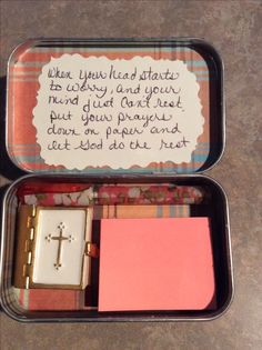 two small tins filled with different types of items and writing on the inside of them