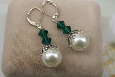 Emerald Green and White Pearl Earrings- Silver Leaf Earrings- Couquette Earrings- Vintage Style 1920's 1930's Earrings- Pearl Drop Earrings  Crystal white pearls that are 12mm  Sitting on top is a silver plated leaf bead cap with three Swarovski emerald green crystals.  They suspend from silver plated lever back ear wires.  1 5/8 inches long They arrive gift boxed with a bow Thanks for looking, Lori Elegant Nickel-free Clip-on Earrings For Evening, Vintage Nickel-free Pearl Earrings For Wedding, Classic Handmade Pearl Earrings For Formal Occasions, Elegant Nickel-free Clip-on Earrings For Wedding, Elegant Green Nickel-free Clip-on Earrings, Classic Handmade Earrings For Party, Vintage Dangle Pearl Earrings For Anniversary, Vintage Dangle Pearl Earrings With Ear Wire, Vintage Round Bridal Earrings For Gifts