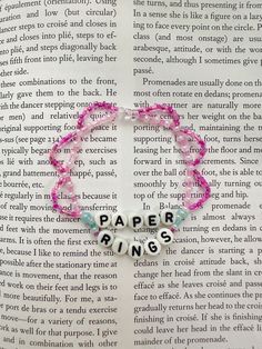 a pink bracelet with beads that says paper rings