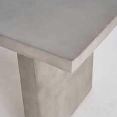 a close up of a metal table on a white surface with no people around it