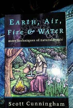 the book earth, air, fire and water by scott cummingham is on display