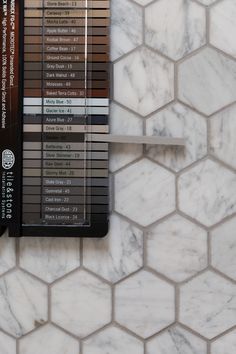 the tile on the wall is white and has different shades of brown, beige, and black