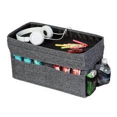 an image of a storage bin with headphones and other items in it on white background