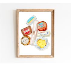 a painting of food in a wooden frame on the wall next to a white wall