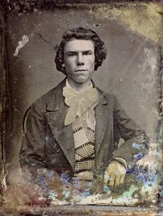 an old photo of a man in a suit and bow tie