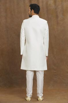 White sherwani with placed floral and sequin embroidery.
Components: 1
Pattern: Embroidered
Type Of Work: Thread,Sequin
Neckline: Mandarin Collar
Sleeve Type: Full
Fabric: Silk
Color: White
Other Details: 
Straight silhouette
Closure: Front closure
Note:
The fabric is silk blend and not pure silk
Churidar, brooch and dupatta worn by the model is not for sale
Occasion: Sangeet,Mehendi and Puja - Aza Fashions Wedding Nehru Jacket With Mirror Work, Wedding Sherwani With Mirror Work In Raw Silk, Naqshi Embroidered Straight Sherwani For Reception, Naqshi Embroidered Sherwani For Reception, Naqshi Embroidered Straight Kurta Sherwani For Reception, Unstitched Sherwani For Reception, White Semi-stitched Sherwani With Mirror Work, Semi-stitched Sherwani With Mirror Work For Wedding, Traditional Raw Silk Sherwani With Mirror Work