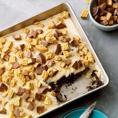 there is a cake in the pan with chocolate and marshmallows on it