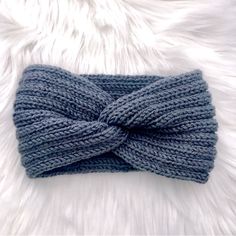 a close up of a knitted headband on a furry surface