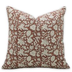 a brown and white pillow on a white background