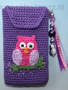 a purple crocheted cell phone case with an owl on it