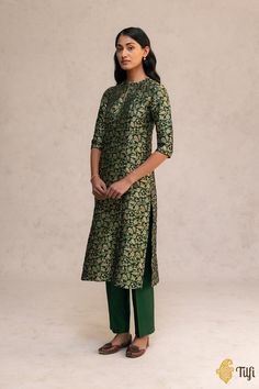 "A forest green straight-cut kurta with a classic Banarasi all-over Shikargah pattern, handwoven using gold zari. Paired with pure Chanderi silk pants for a structured and elegant silhouette.\u00a0\n\n\nColor - Forest Green\u00a0\n\n\nFabric - Pure satin silk kurta, pure Chanderi silk pants\n\n\nTechnique - Classic handwoven Banarasi art passed down through generations of weavers in a combination of flora and fauna motifs in the Shikargah pattern.\n\nAll our garments are Made on Order. Please allow 12-14 business days for dispatch.\u00a0\n\nNote: Since this product is handwoven, there might be slight irregularities. But don't you think these add to the singular charm of handloom beauties?\n\u00a0" Green Silk Salwar Kameez For Formal Occasions, Green Silk Unstitched Suit For Formal Occasions, Formal Green Silk Unstitched Suit, Traditional Dark Green Festive Sets, Traditional Green Lawn Suit For Formal Occasions, Formal Green Kurta For Festive Occasions, Traditional Green Formal Lawn Suit, Formal Festive Green Kurta, Green Formal Traditional Wear For Transitional Season