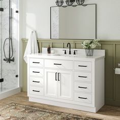 a bathroom with a sink, mirror and shower